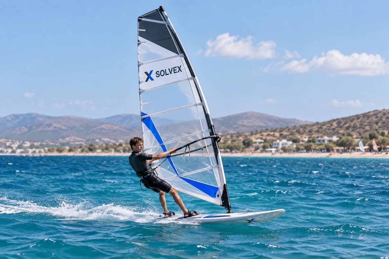 Solvex windsurfing concept: a young athlete riding across turquoise water with a branded sail.